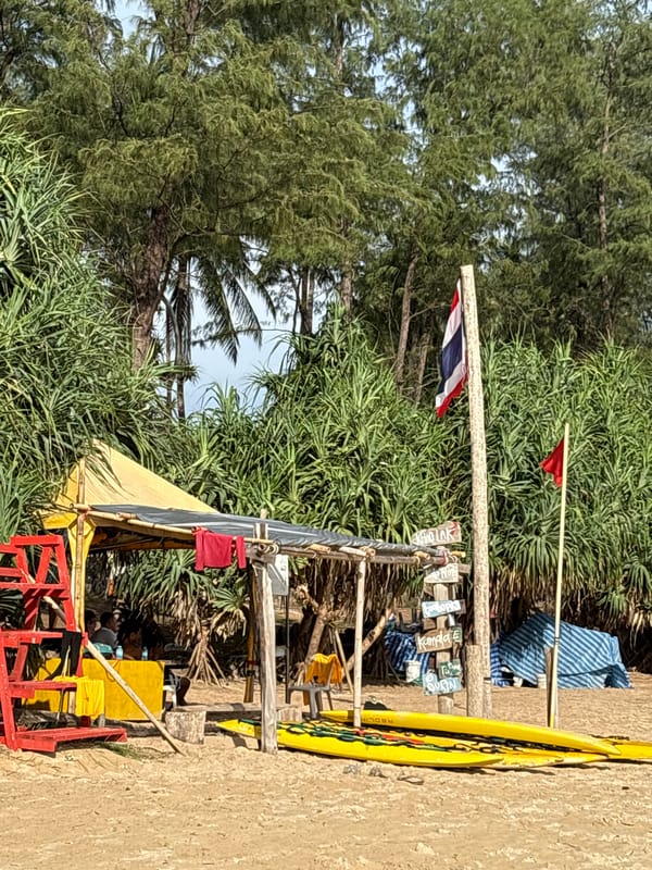 Laid-back morning at Karon Beach with surfers and shoreline activity