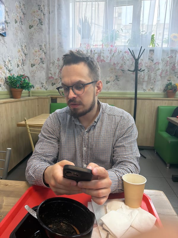 Man uses phone during breakfast in Krasnoyarsk