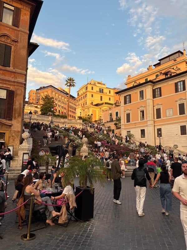 Afternoon crowds gather at Rome's Spanish Steps, street performer entertains