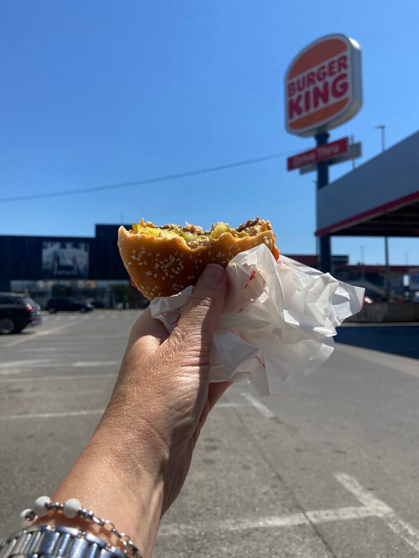 Person eats burger outside Burger King in Podgorica