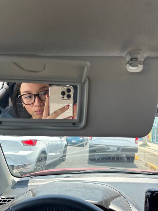 Woman takes selfie in car mirror in Mexico