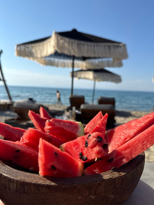 Watermelon and fried food at a Greek beach spot