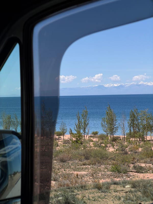 Vehicle passenger captures landscape view in Kaji-Say, Kyrgyzstan
