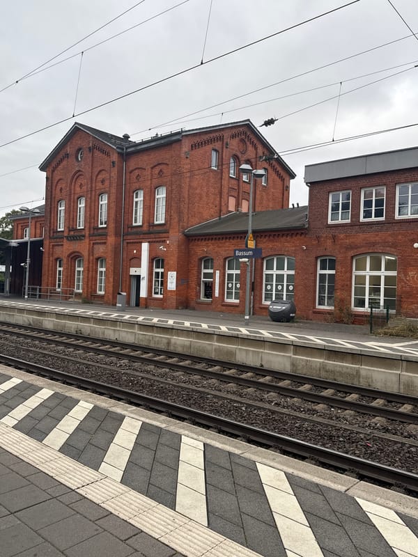 Freight train rolls through Bassum station on a quiet morning