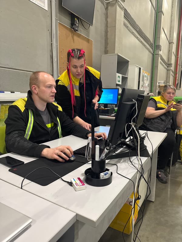 Three people observed at work station in Lupanovo warehouse