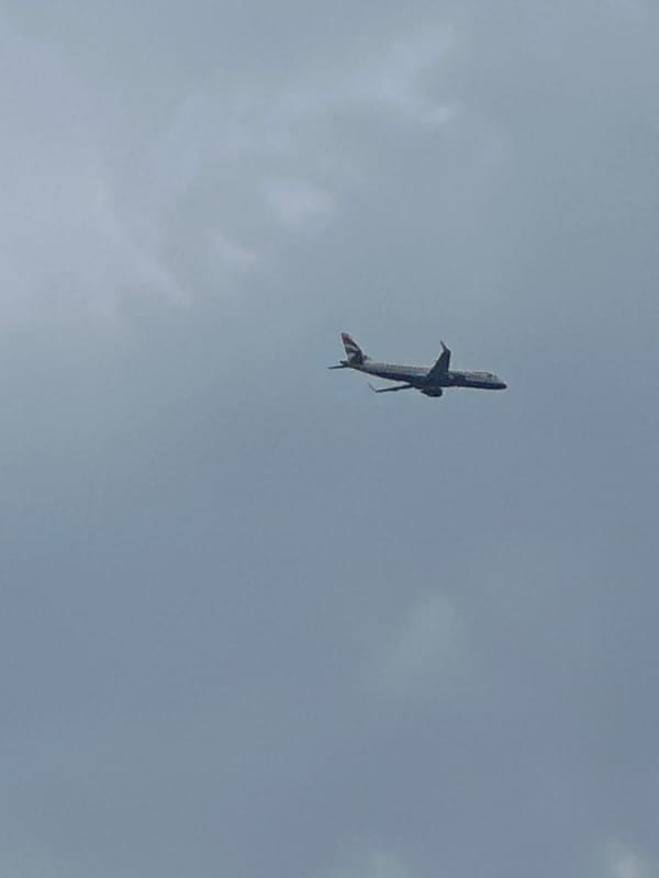 Commercial jets tracked crossing cloudy London skies
