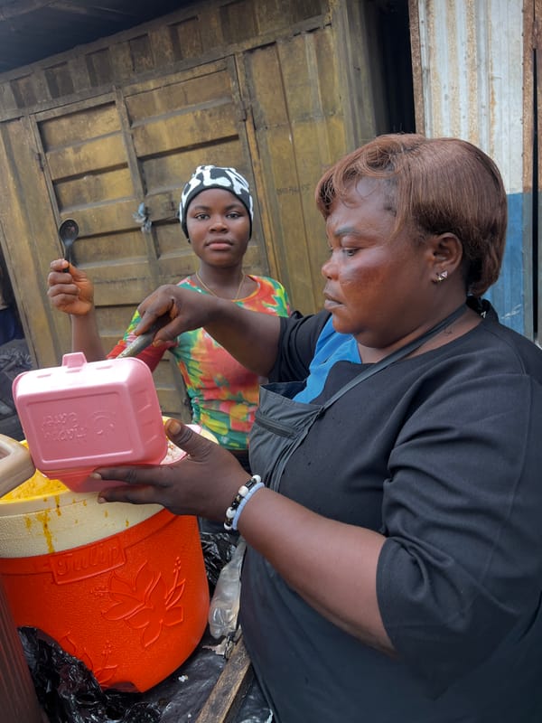 Women shop and serve at busy street market