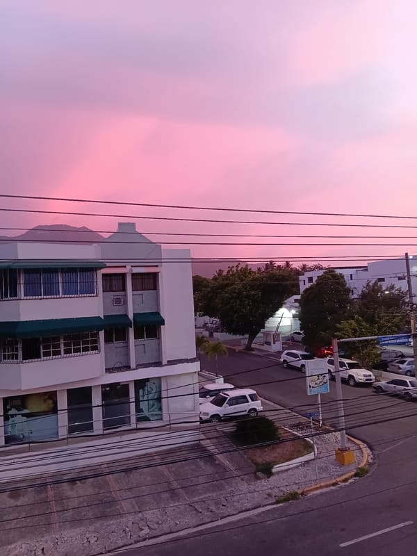 Pink sunset sky over Puerto Plata streets at dusk