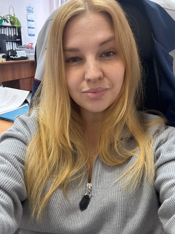 Woman photographed twice in office setting in Rusanovo, Russia