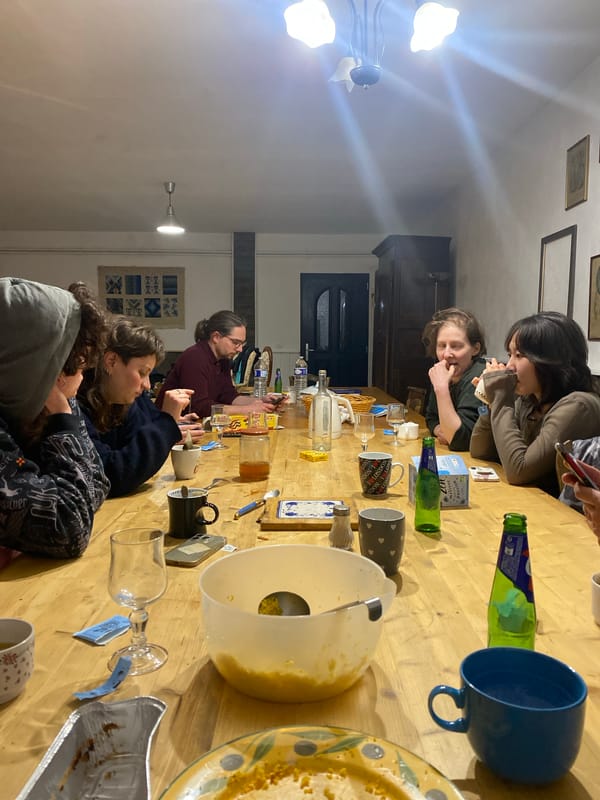Six people gather around wooden table in French commune
