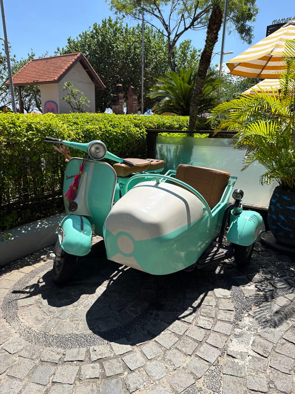 Vintage Vespa and local meal captured in Kuta