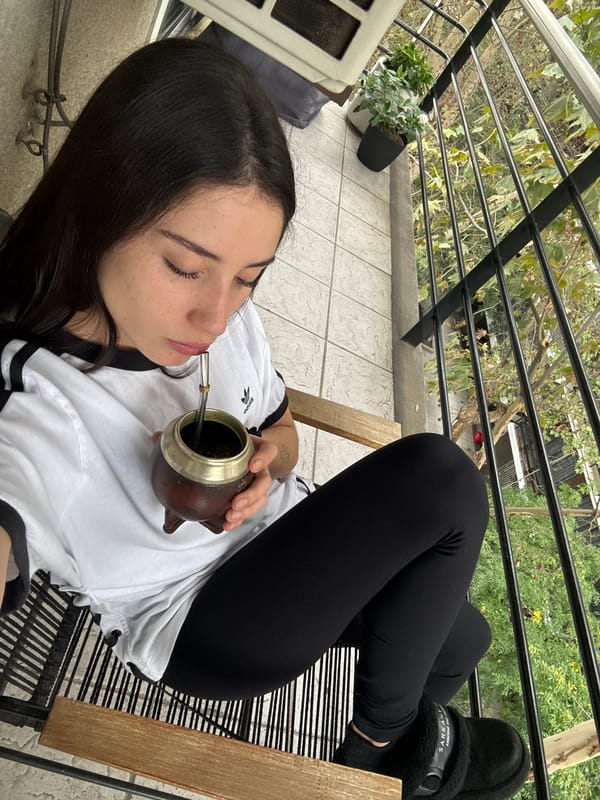 Woman enjoys mate tea, healthy snacks on Buenos Aires balcony