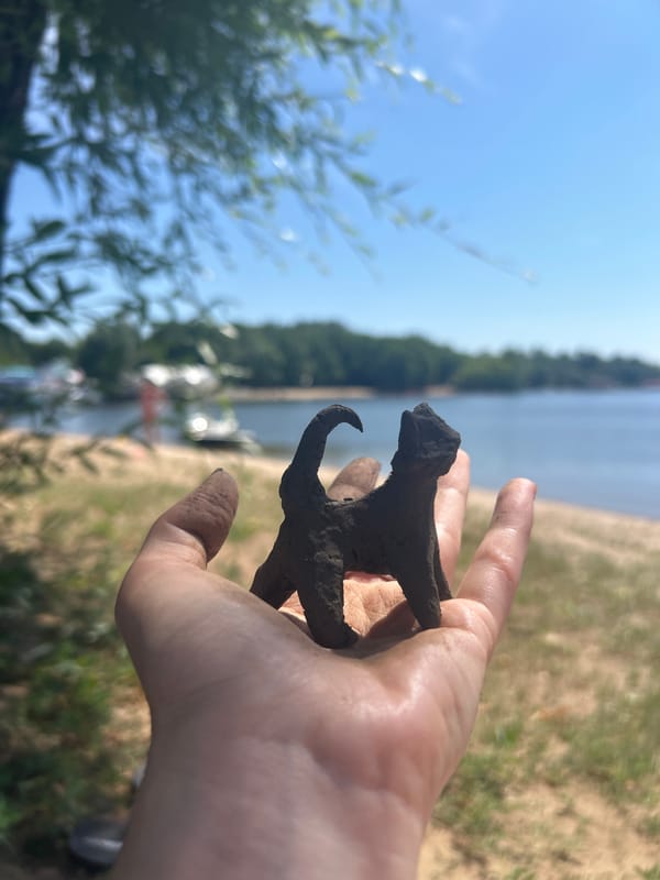 Handmade clay cat figurine by the waterfront in Engels