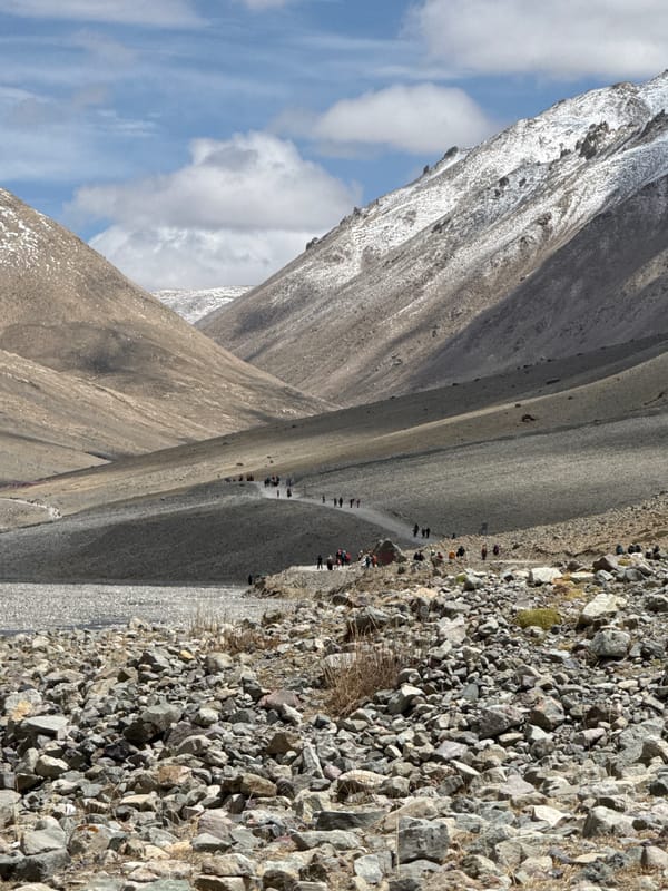 Hikers traverse rocky mountain path in remote China region