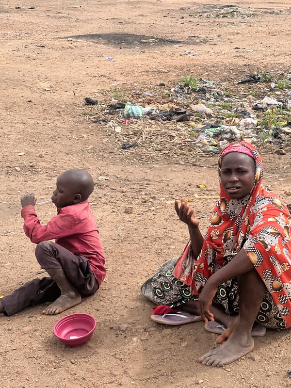 Woman and young man observed on ground in Bukuru