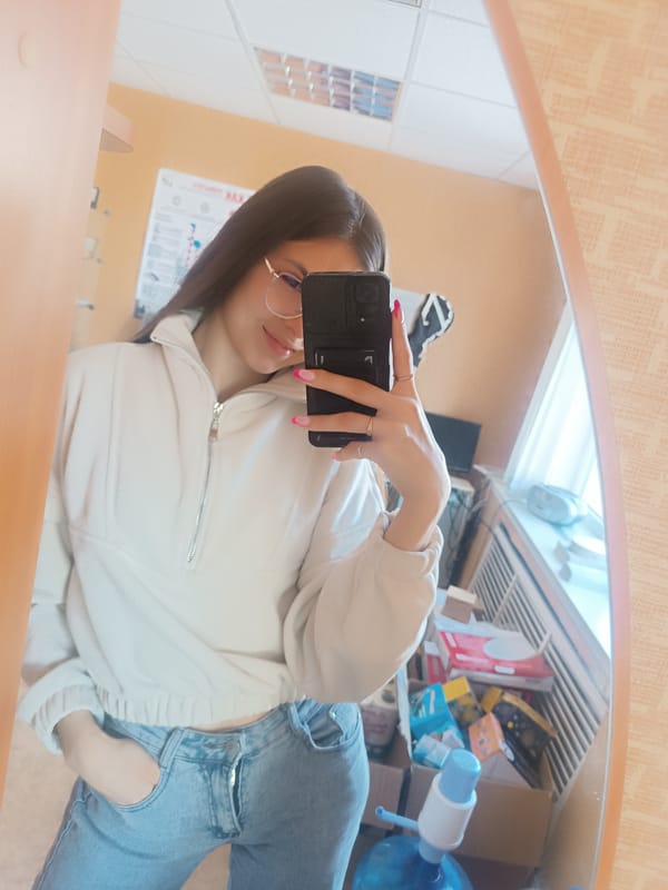 Woman Takes Mirror Selfies in Light Sweatshirt and Jeans