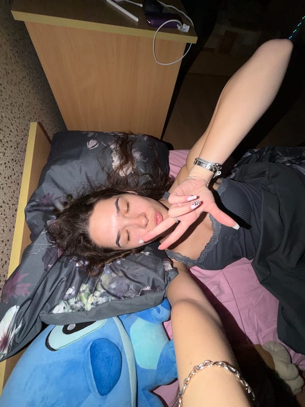 Young woman takes multiple selfies lying down in Sofia