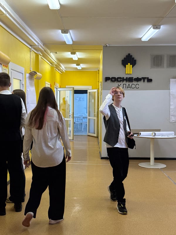 Students gather in Krasnoyarsk school hallway, one with taped mouth