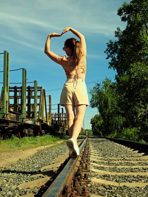 Woman walks on railroad tracks in Chaikovsky, Russia