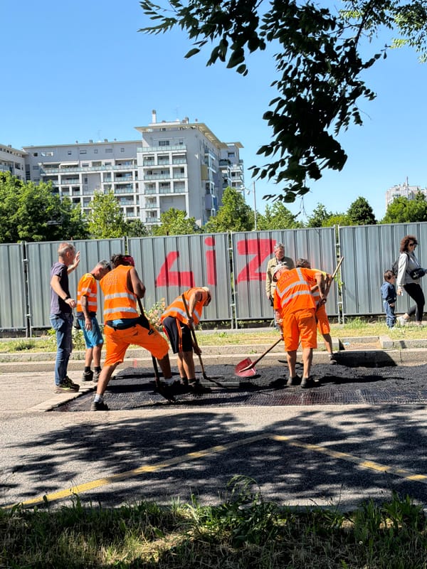 Road crews repair street in Milan