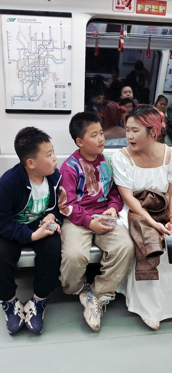 Two boys play on train car floor