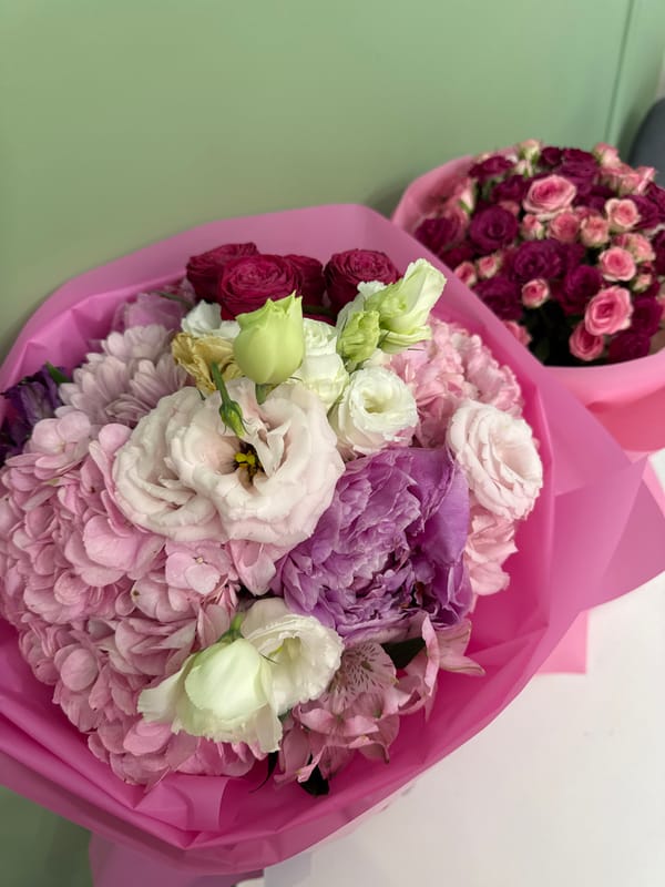 Pink-wrapped flower bouquets from a floral shop, multiple angles