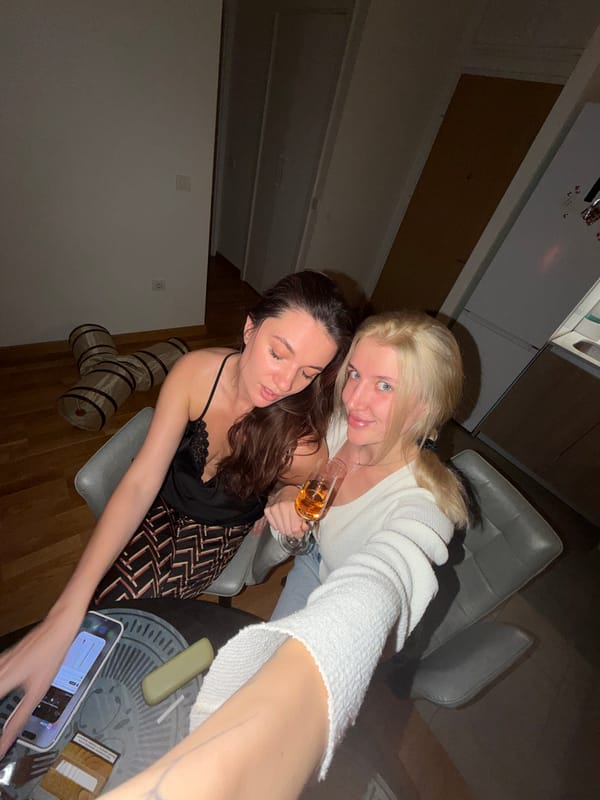 Two women celebrate with sushi and drinks in Belgrade