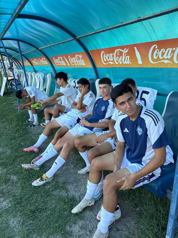 Soccer squad trains at a sunny Bukhara sports facility