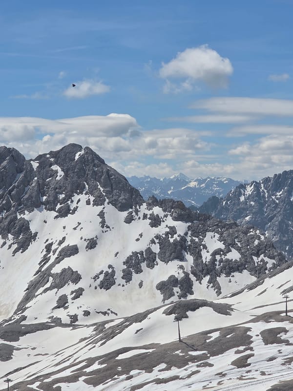 Dark triangular object spotted over snowy mountain landscape