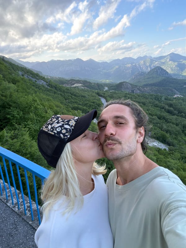 Couple photographs scenic moment at Montenegro mountain overlook