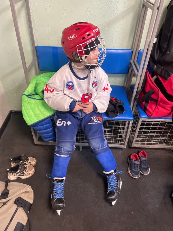 Young hockey player rests in Krasnoyarsk locker room