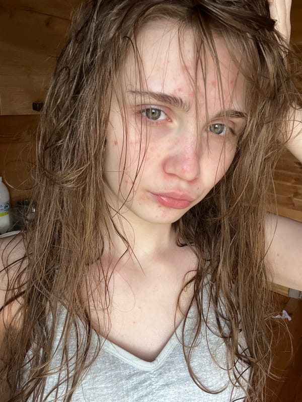 Woman takes morning selfies in wooden room, Ashkadar