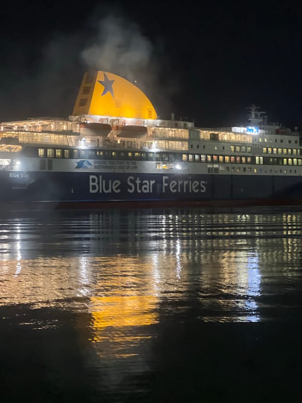 Blue Star Ferry emits steam in Piraeus harbor at night