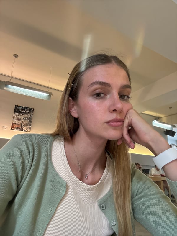 Woman takes selfie in green cardigan
