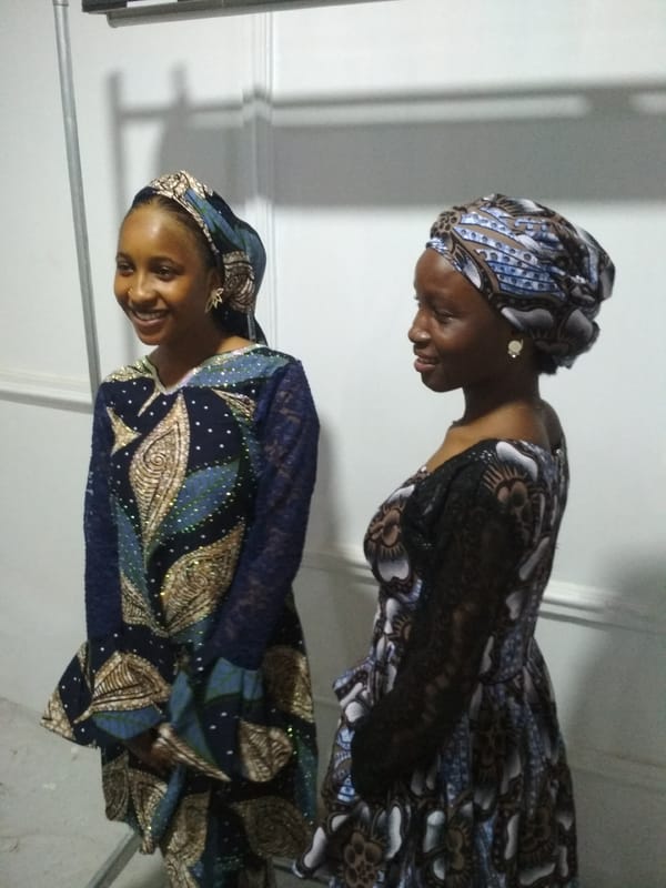 Women in traditional dress photographed during indoor gathering session