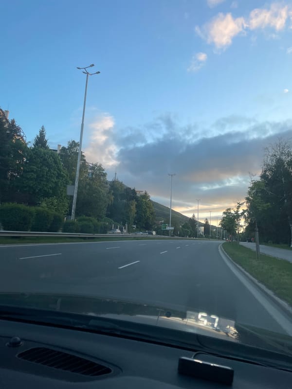 Driver documents highway journey with dramatic sky conditions