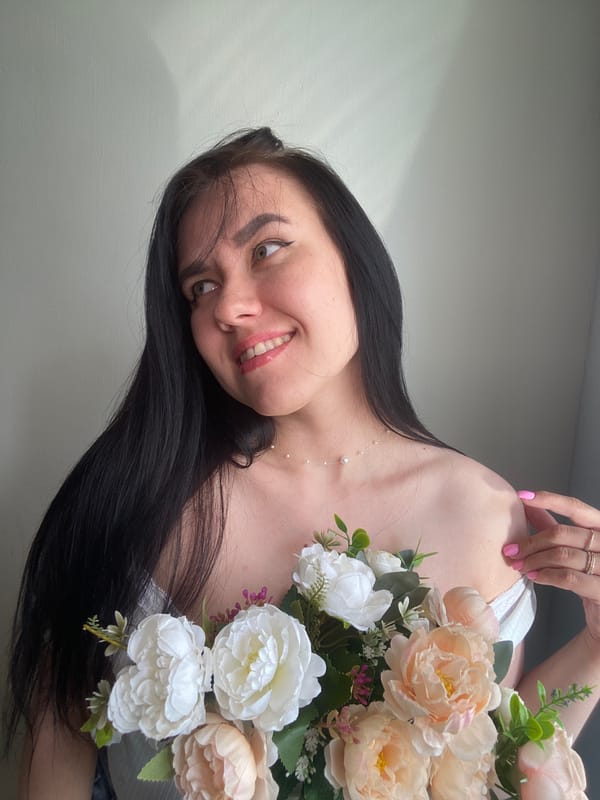Woman poses with flower bouquet in Chaikovsky, Russia