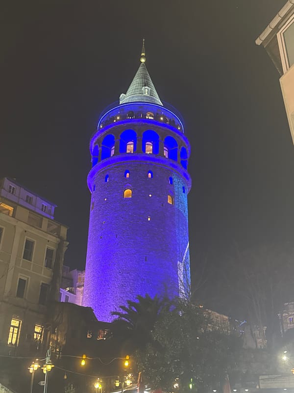 Galata Tower glows blue in Istanbul evening illumination