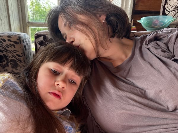 Mother and daughter share quiet morning moments with pet
