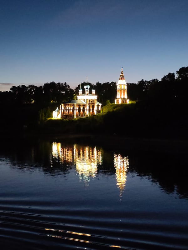 Tutaev's illuminated cathedral complex reflected on the Volga at night
