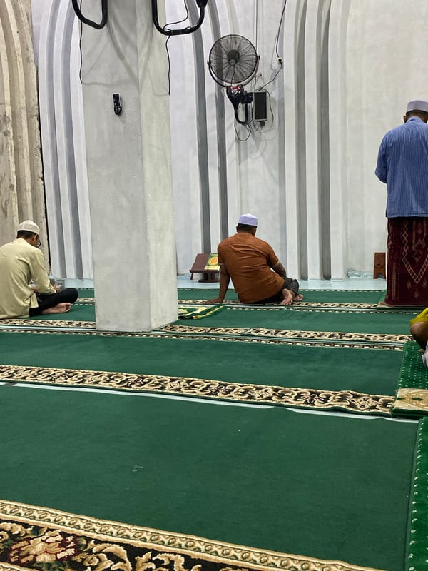 Men gather for midday prayers at Lhokseumawe mosque
