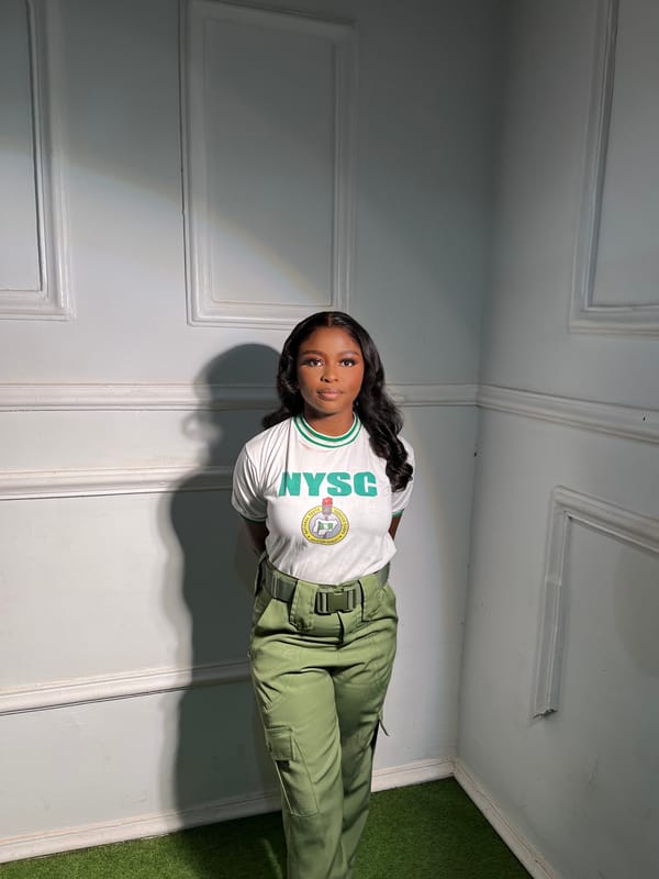 Woman poses in NYSC uniform during service year in Jos