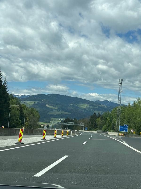 Vehicle travels curved highway section near Bad Sankt Leonhard, Austria