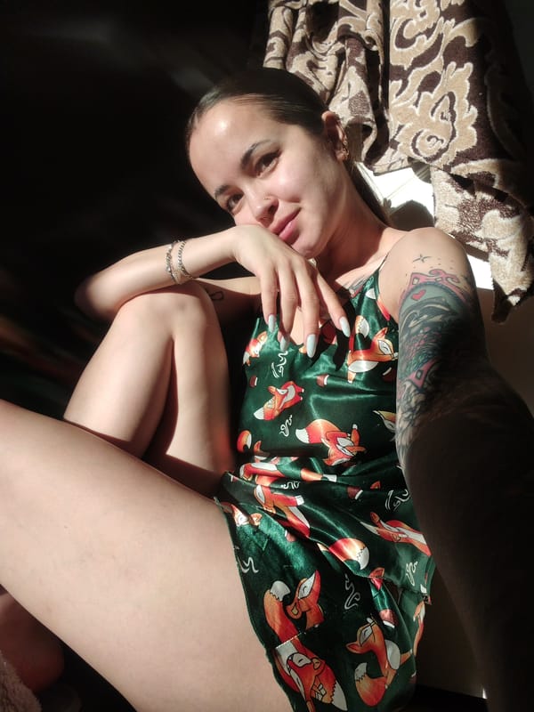 Person in fox-print pajamas photographed indoors with multiple piercings