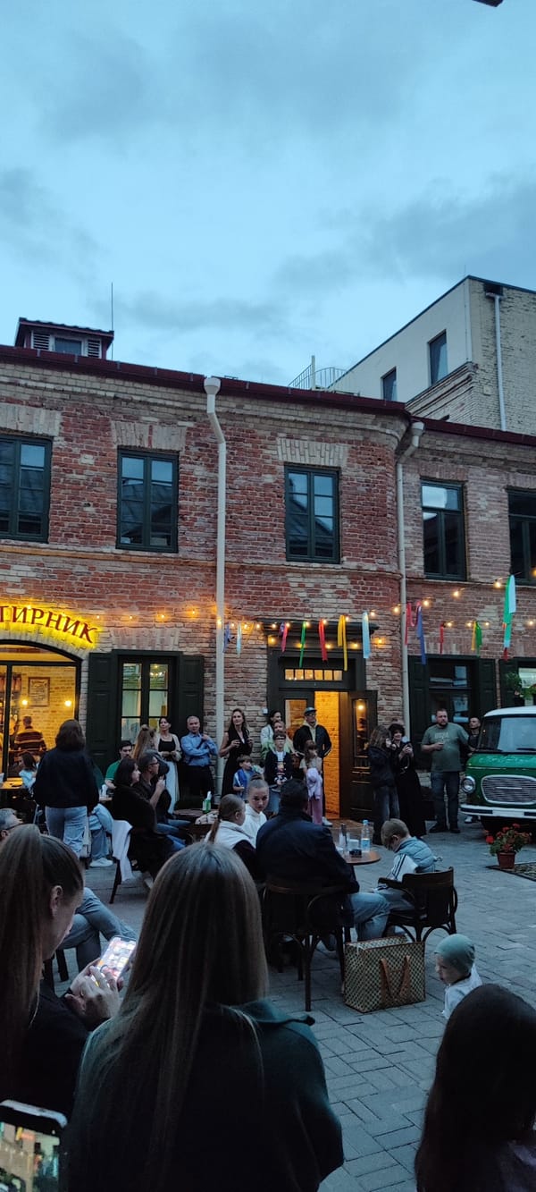 Live acoustic set in a Hrodna courtyard venue, evening.