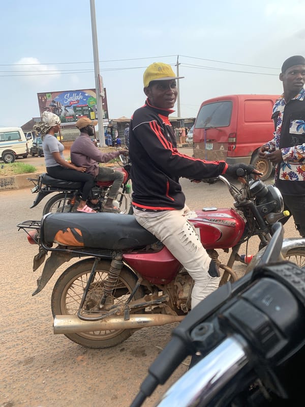 Motorcycle traffic and street life along a Shagamu road