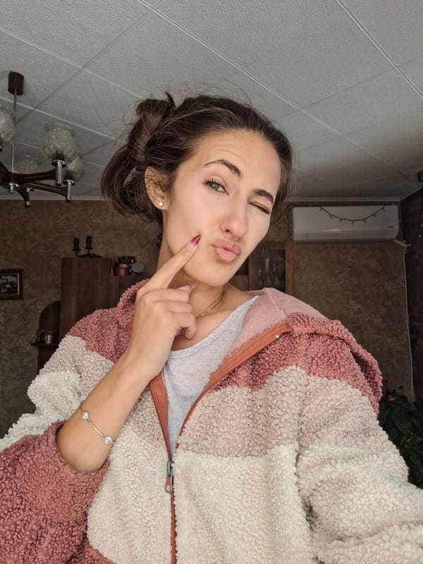 Woman poses playfully for photos in Bulgarian home Friday morning