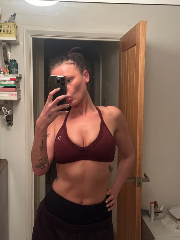 Woman takes bathroom selfie in workout attire