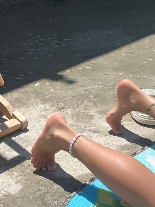 Sunny backyard morning: towels, deck chairs, and bare feet
