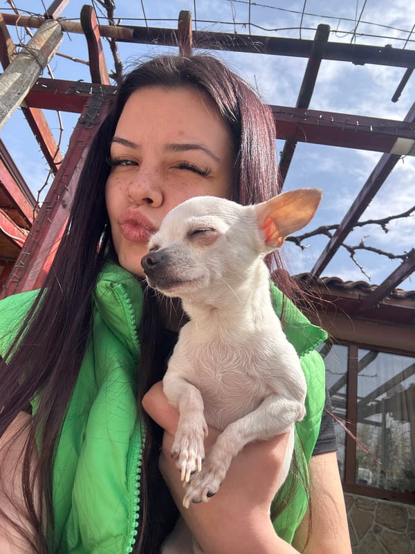 Woman enjoys morning coffee with white dog in Bulgaria